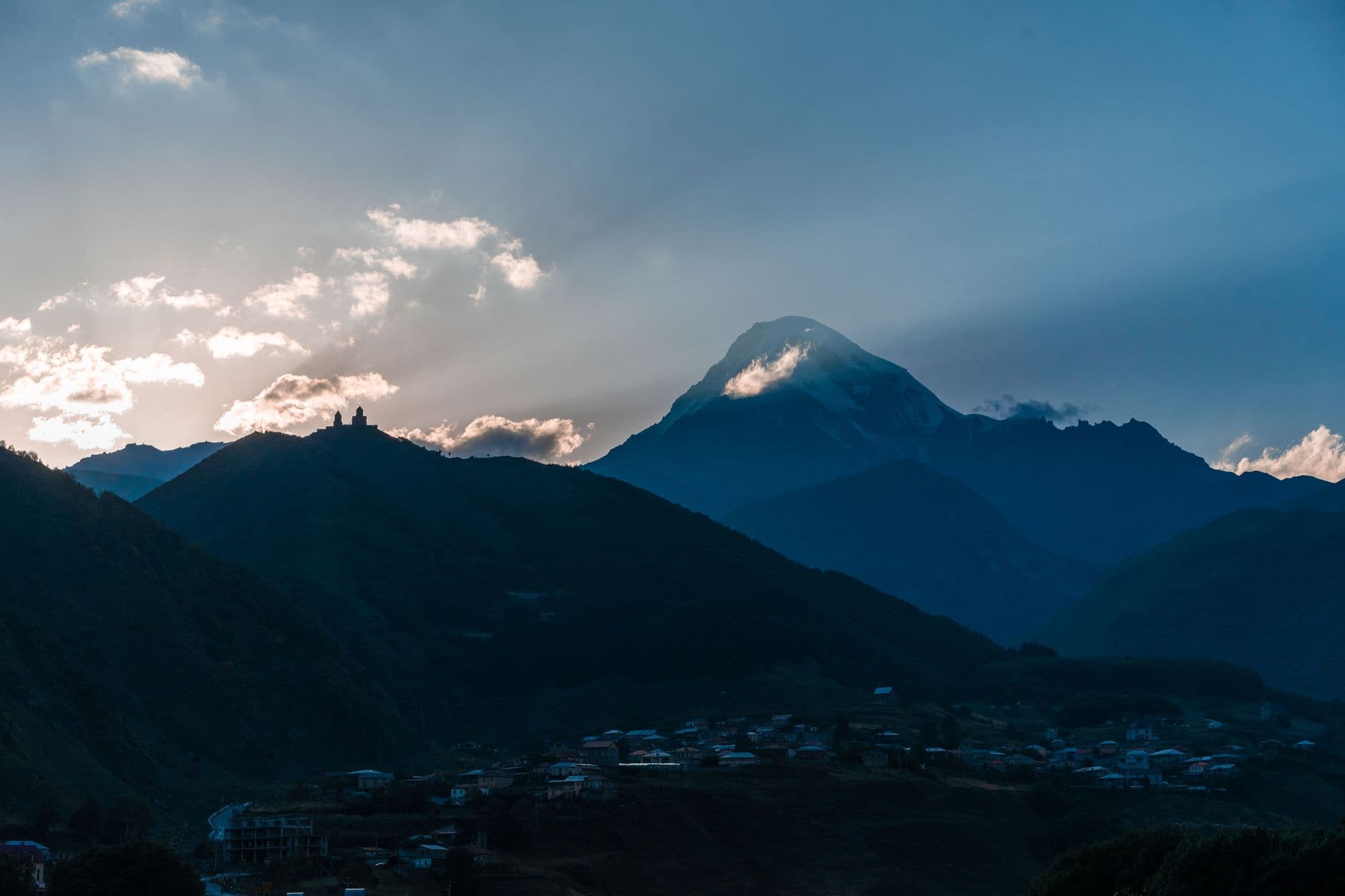 Mount Kazbek and Gergeti Trinity Church in the golden morning light